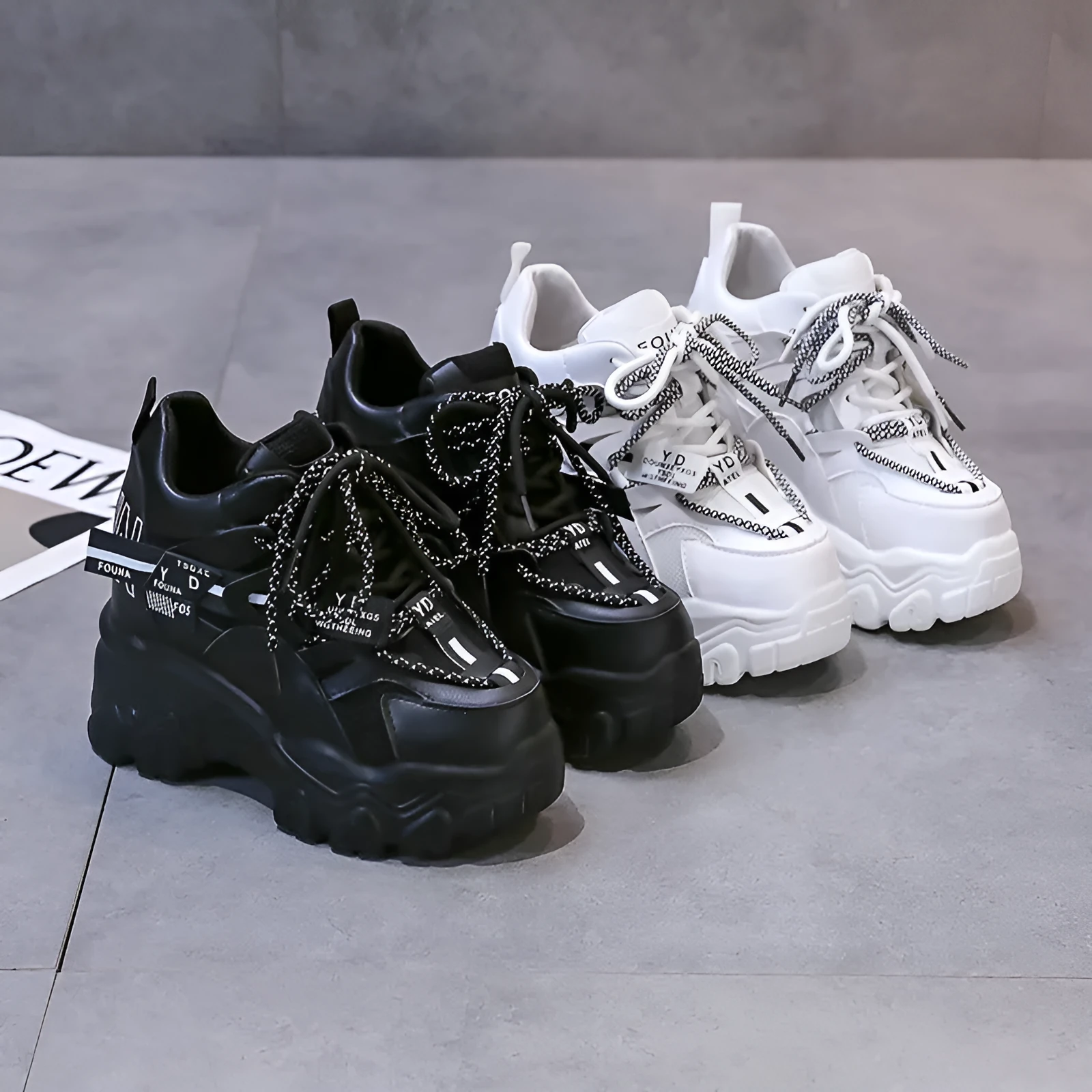 Women's white and black breathable mesh platform sports shoes with cross-strap and rubber sole.