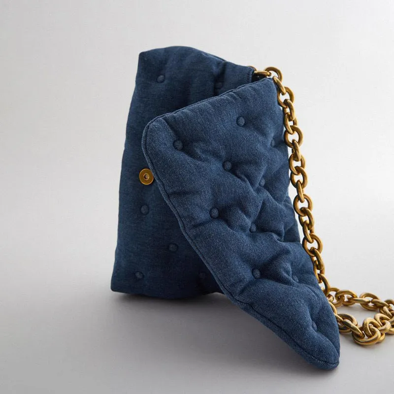 Blue oversized denim quilted shoulder bag with thick chain strap and padded buttons