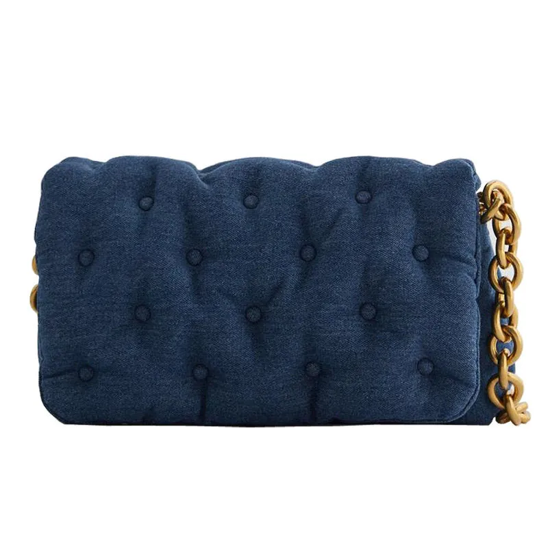 Blue oversized denim quilted shoulder bag with thick chain strap and padded buttons