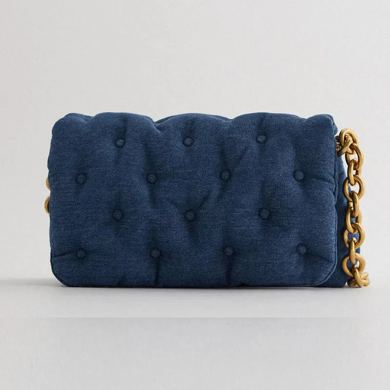 Blue oversized denim quilted shoulder bag with thick chain strap and padded buttons