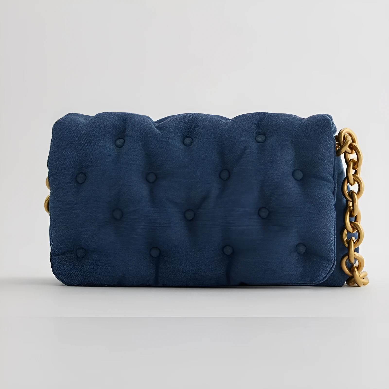 Blue oversized denim quilted shoulder bag with thick chain strap and padded buttons