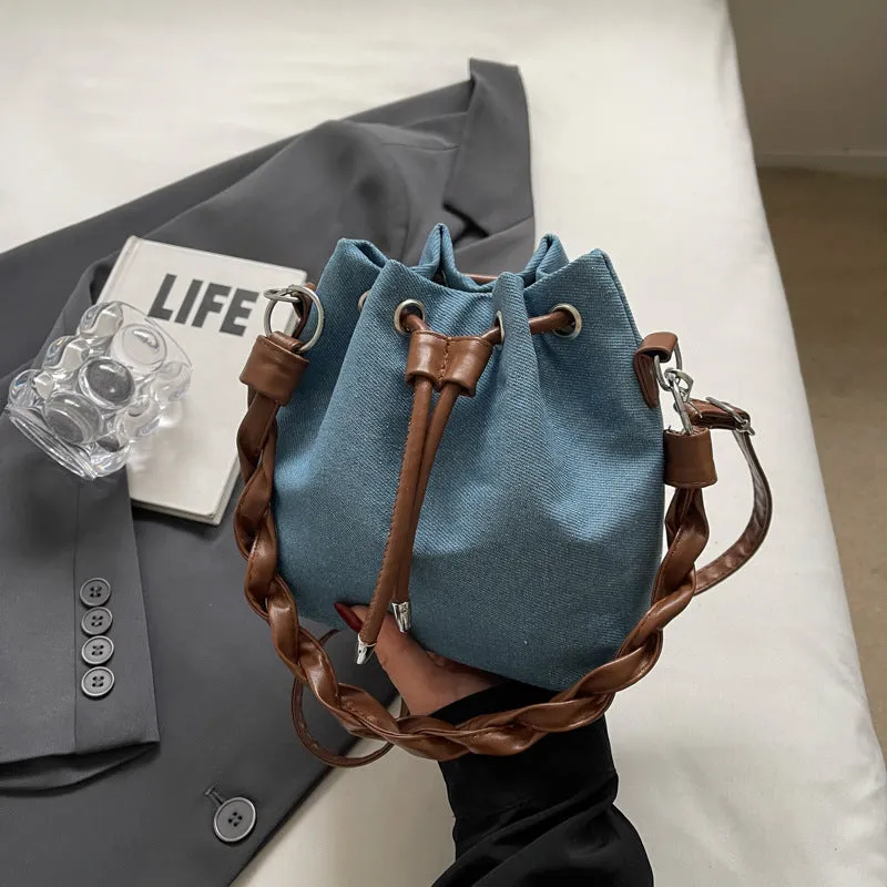 Blue one-shoulder cross body bucket bag with synthetic leather lining and sandwich pocket