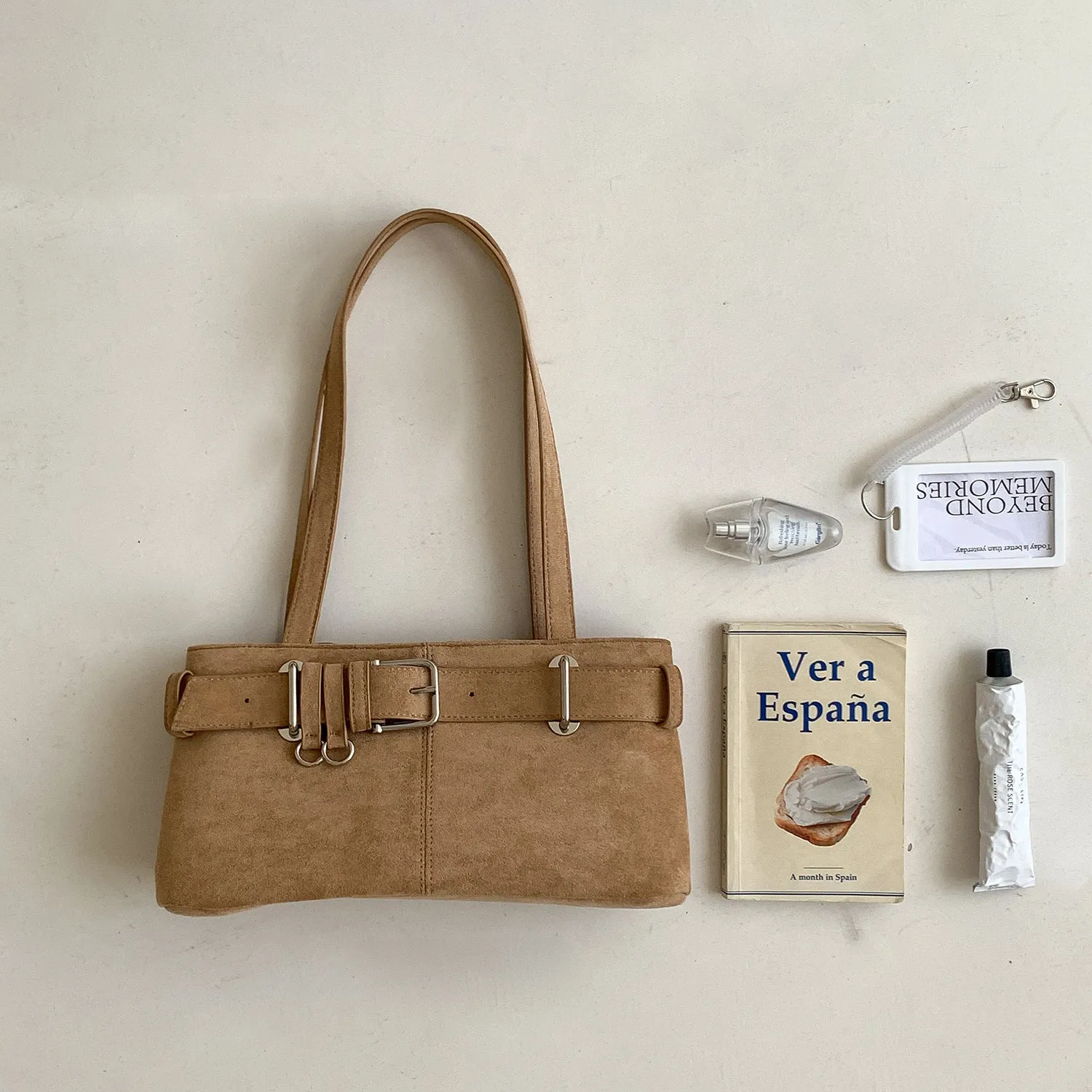 Retro minority design underarm bag in apricot colour with horizontal square shape and double shoulder straps.