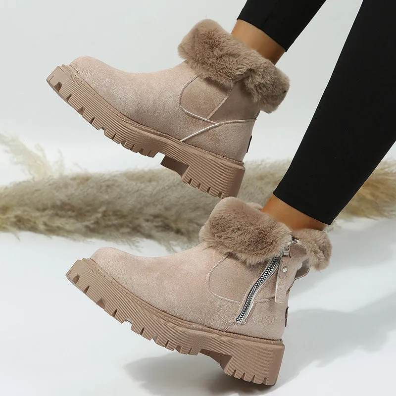 Women's black snow boots with foldable plush tube, suede upper, and rubber sole on winter pavement