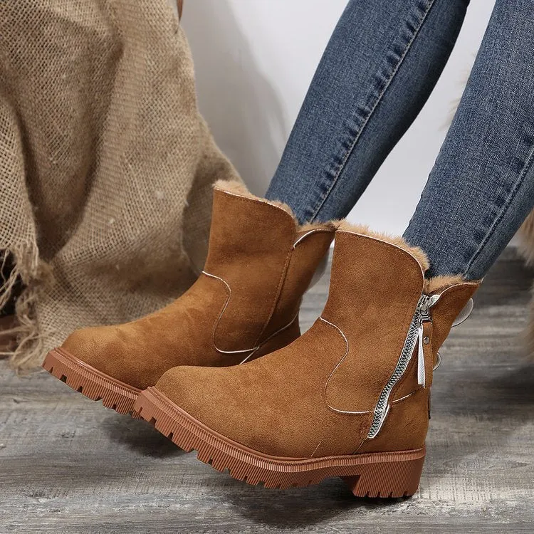 Women's black snow boots with foldable plush tube, suede upper, and rubber sole on winter pavement