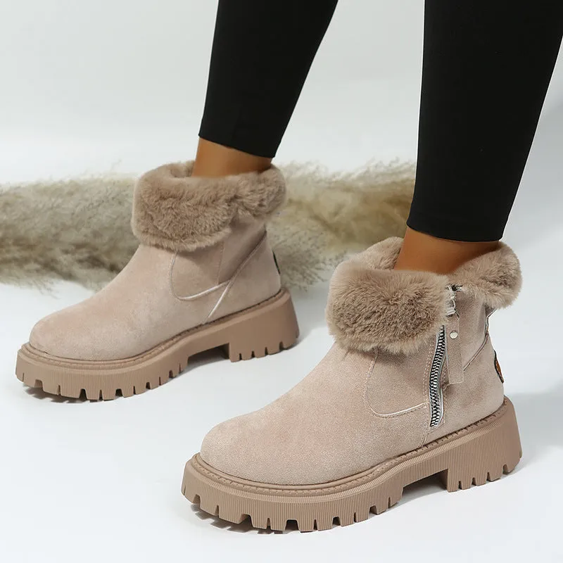Women's black snow boots with foldable plush tube, suede upper, and rubber sole on winter pavement