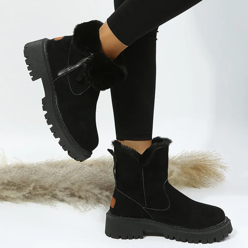 Women's black snow boots with foldable plush tube, suede upper, and rubber sole on winter pavement