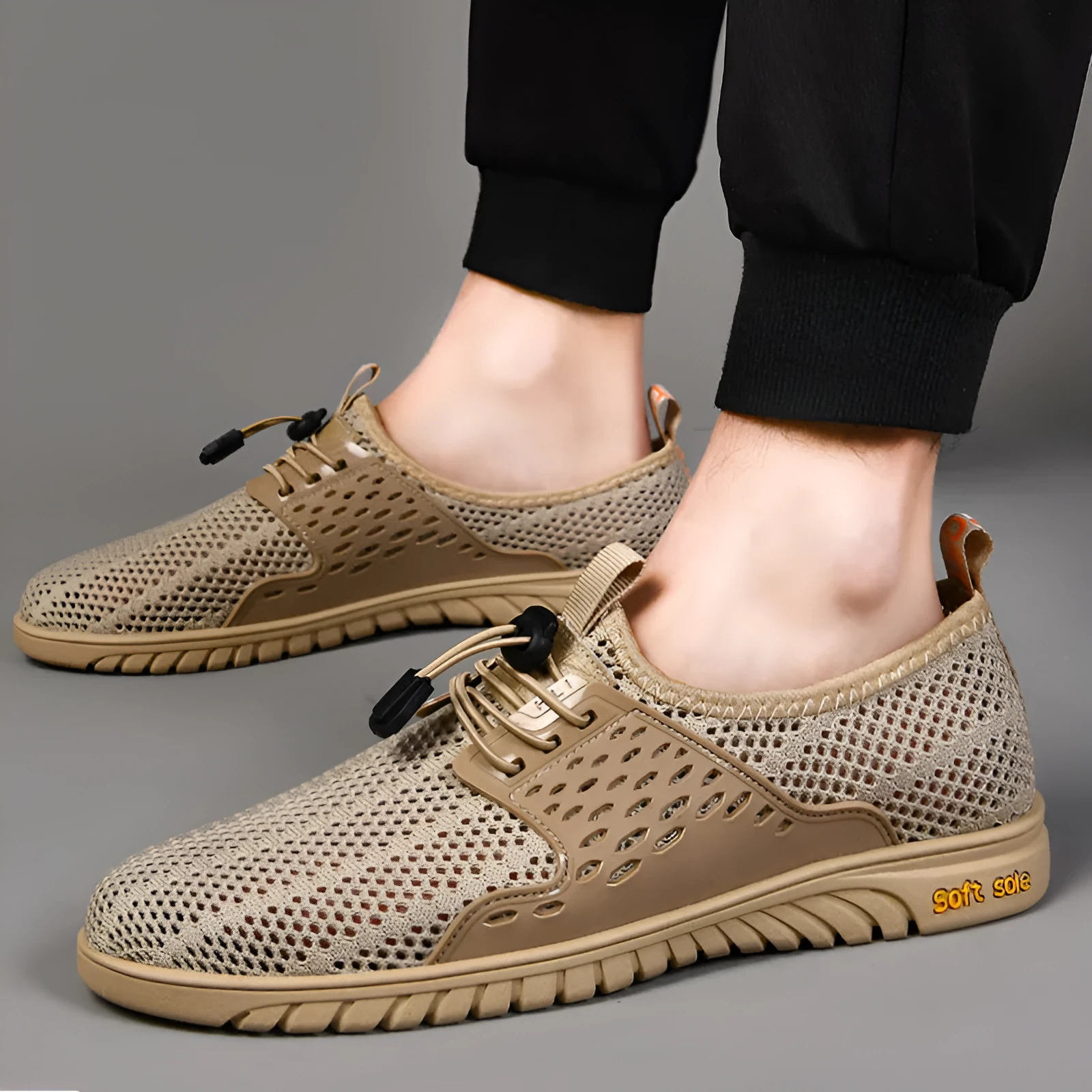 Men's black mesh casual sneaker with elastic band and rubber sole on a light background.