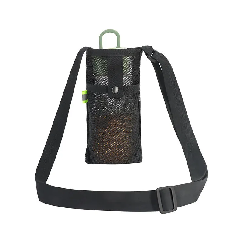 Nylon water bottle holder in black with adjustable shoulder strap on a beach setting