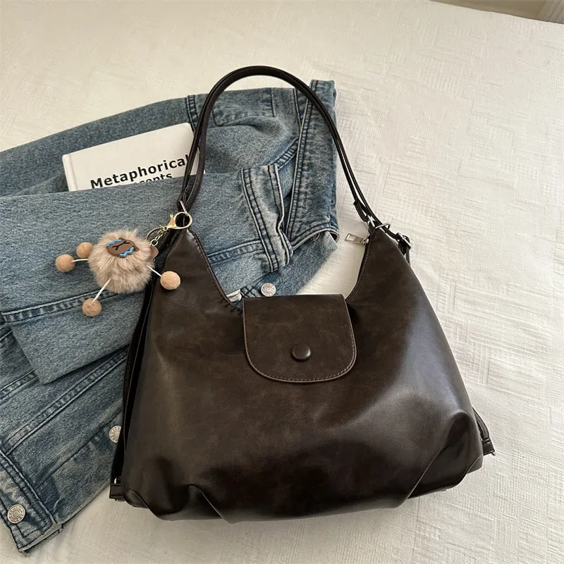 Textured PU leather women's single strap shoulder bag in a horizontal square shape, shown in black colour.