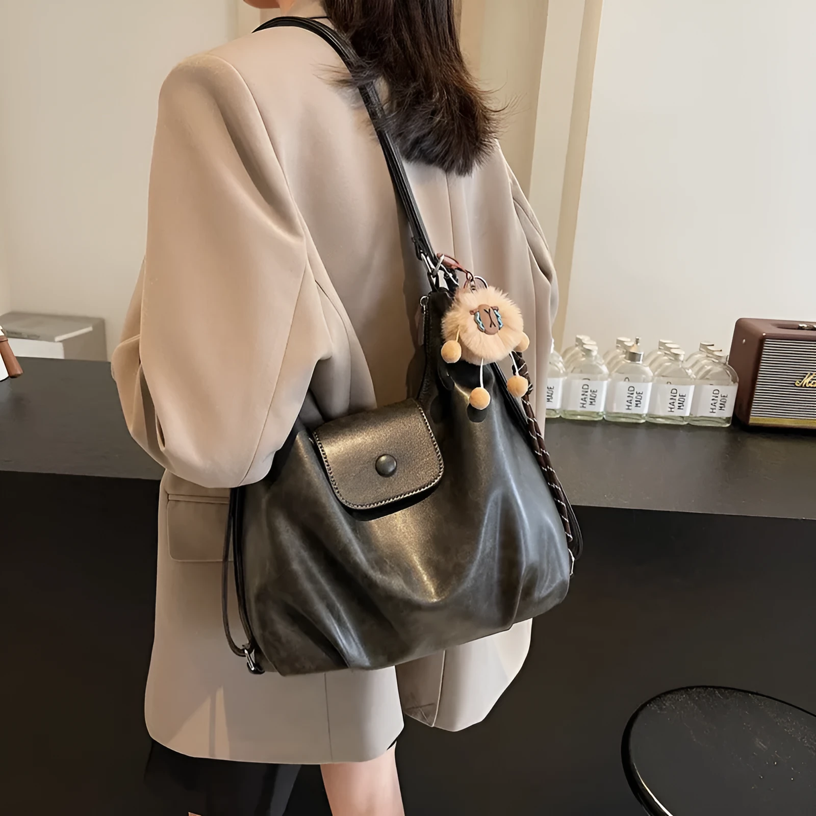 Textured PU leather women's single strap shoulder bag in a horizontal square shape, shown in black colour.