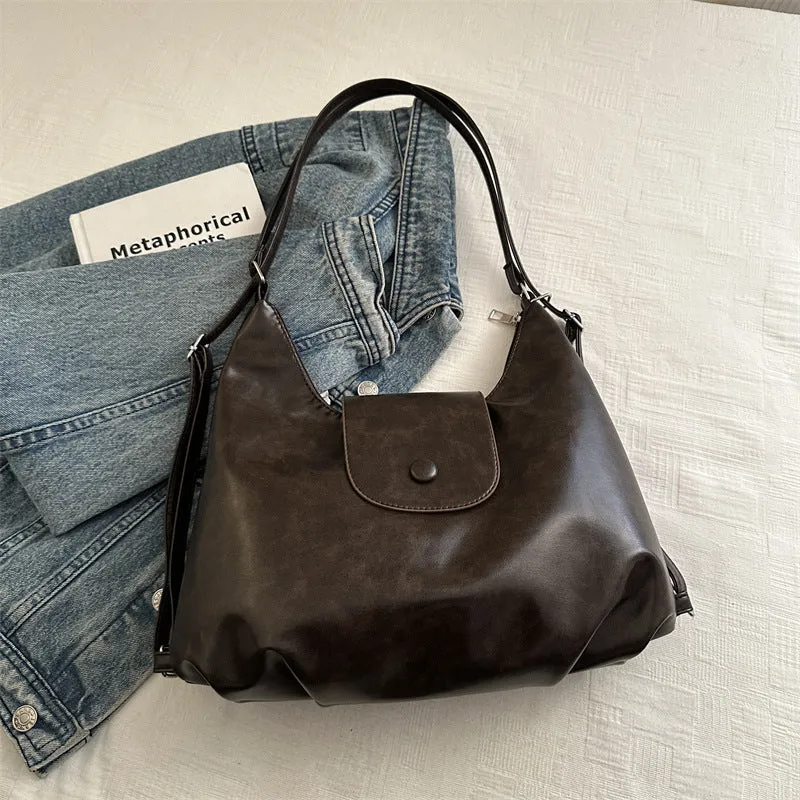Textured PU leather women's single strap shoulder bag in a horizontal square shape, shown in black colour.