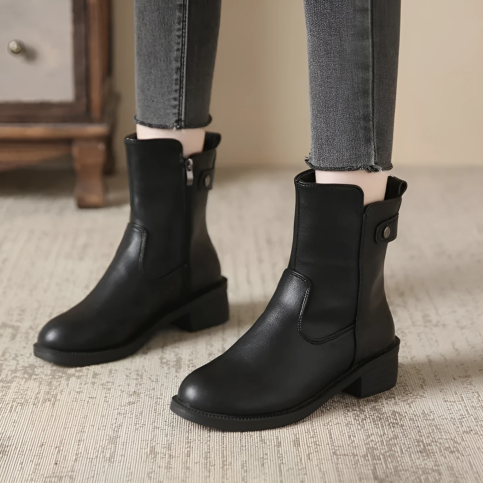 Women's black low heel round toe side zip ankle boots showing front and side views