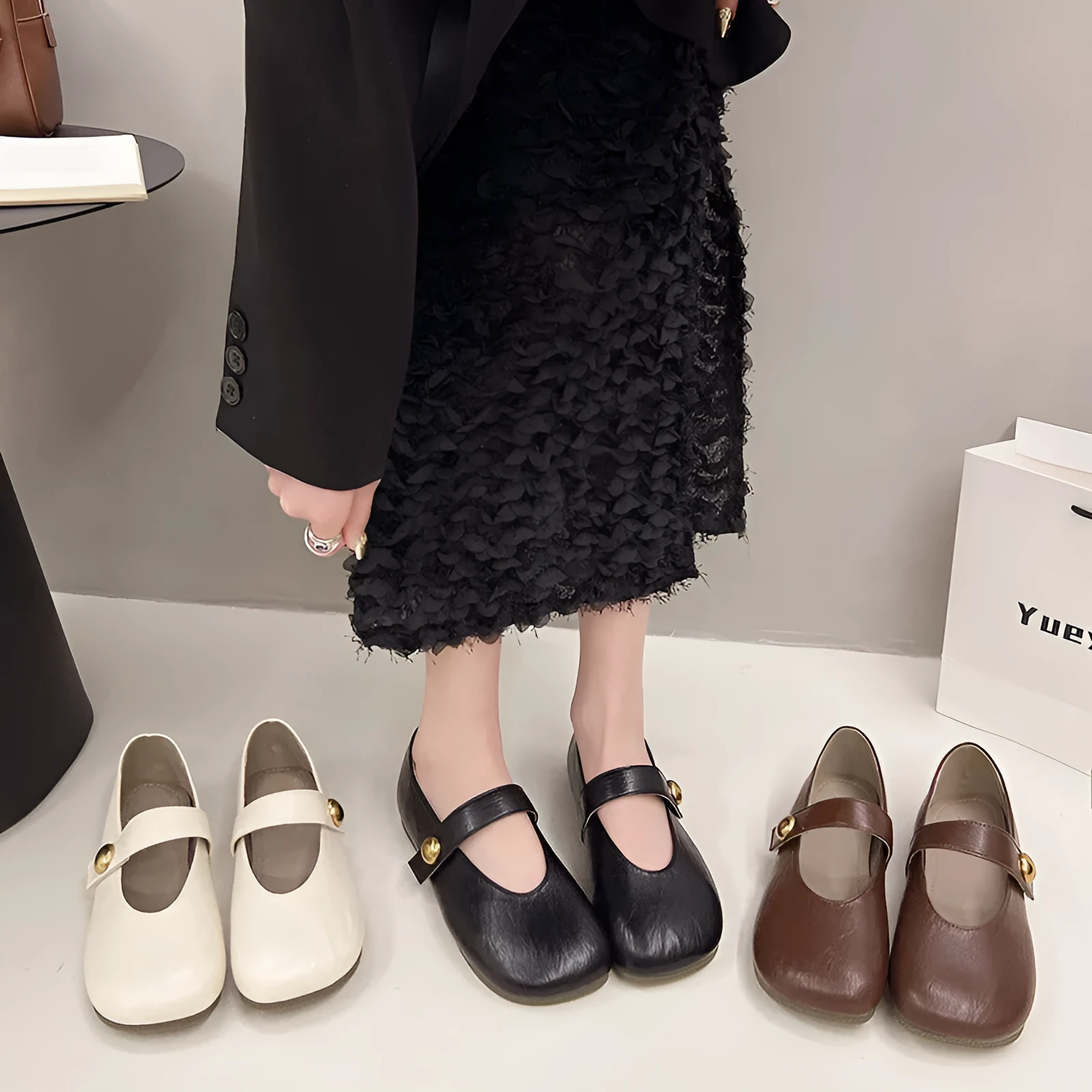 Women's casual flat heel buckle pumps in black with round toe and belt buckle detail