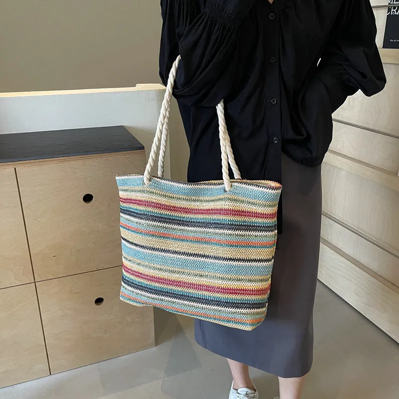 Blue woven nylon shoulder bag with single strap and straw texture.