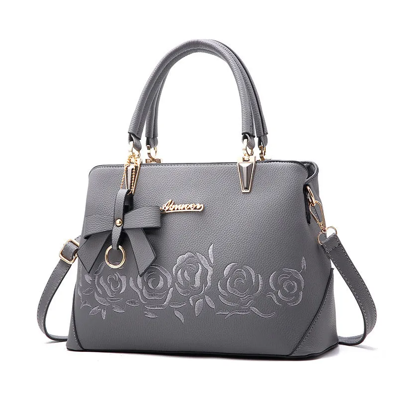 Women's large leather messenger bag with tassel and embroidery in wine red colour