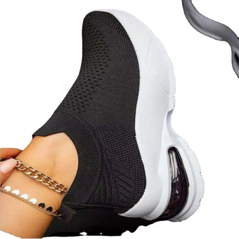 White women's mesh sneakers with rubber sole and flat heel shown from side angle