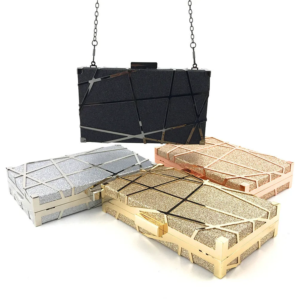 Women's small square glitter chain shoulder bag with lock closure, gold colour, on display