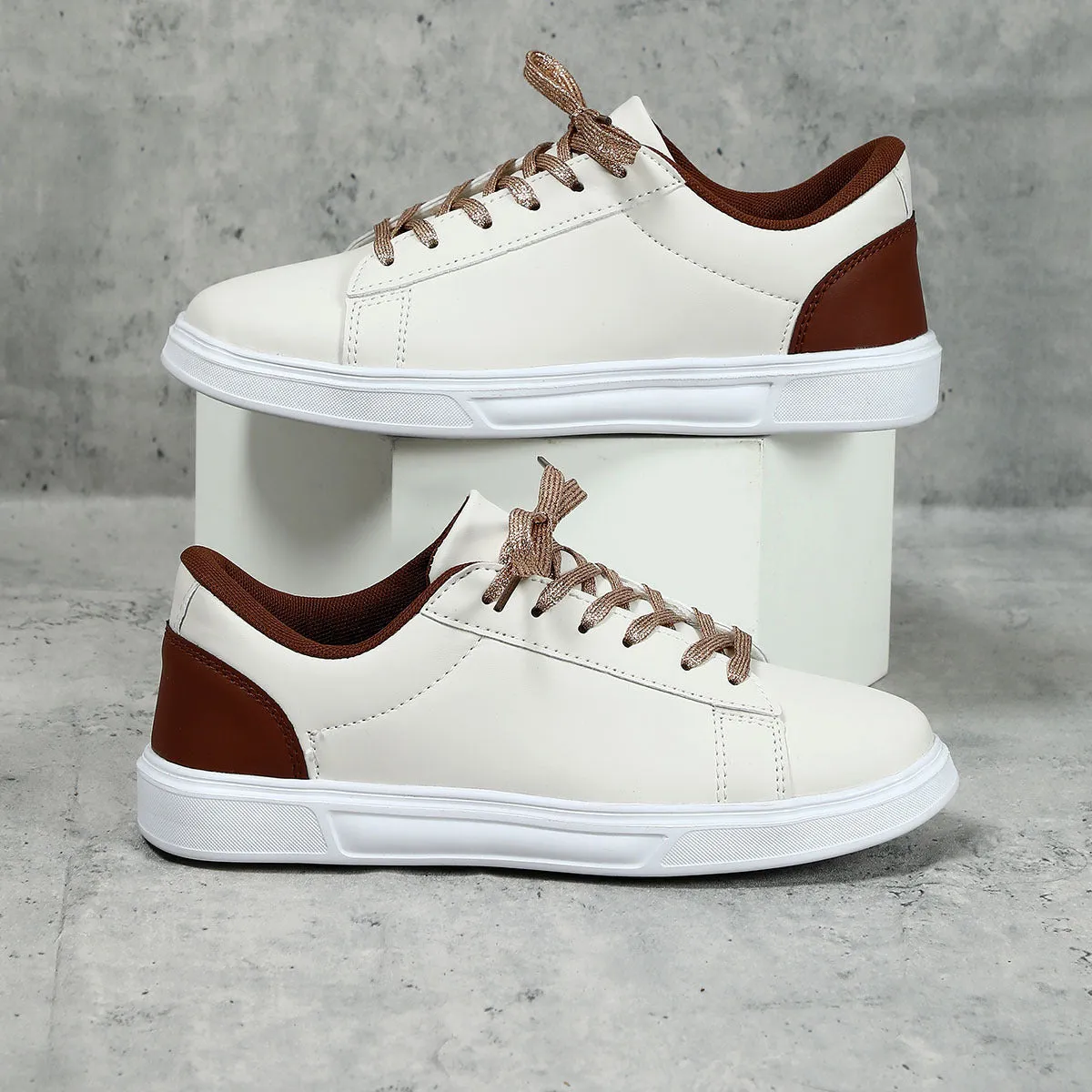 Beige brown platform skateboard sneakers with a cross-strap and round toe on a white background.