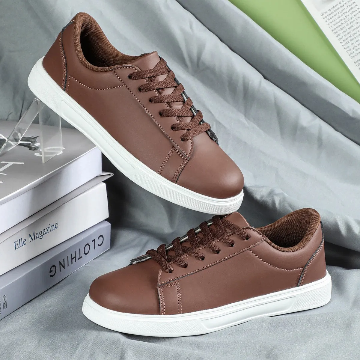 Beige brown platform skateboard sneakers with a cross-strap and round toe on a white background.