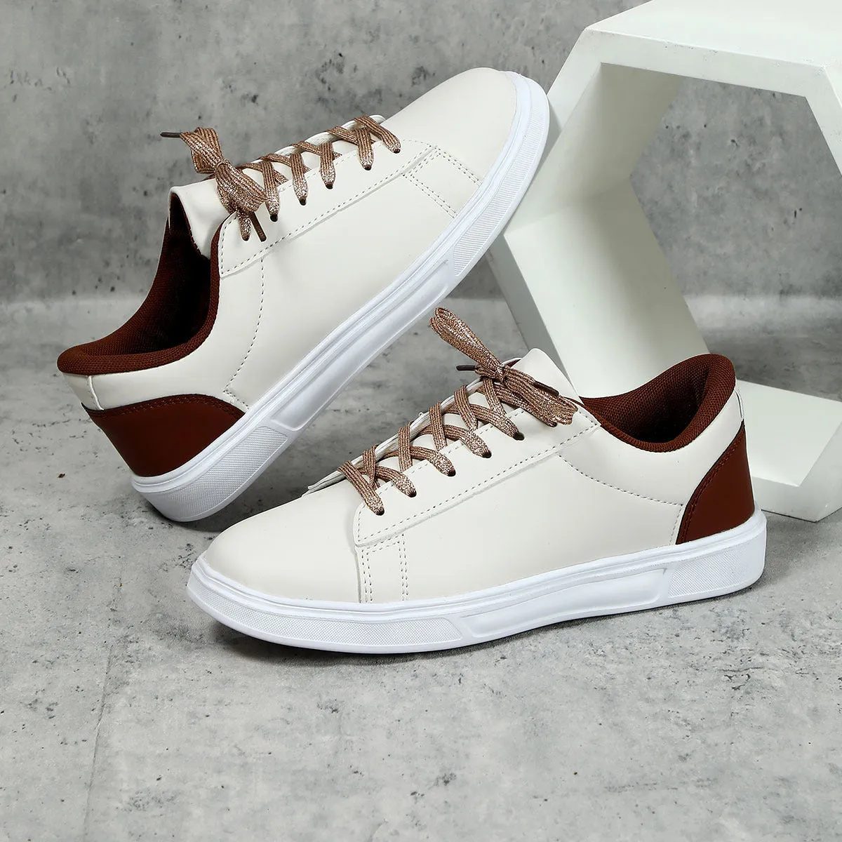 Beige brown platform skateboard sneakers with a cross-strap and round toe on a white background.
