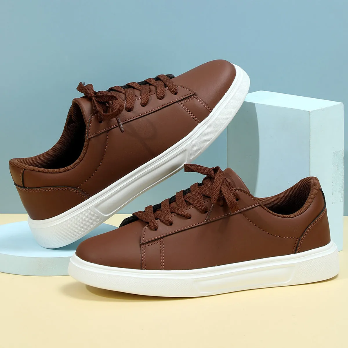 Beige brown platform skateboard sneakers with a cross-strap and round toe on a white background.