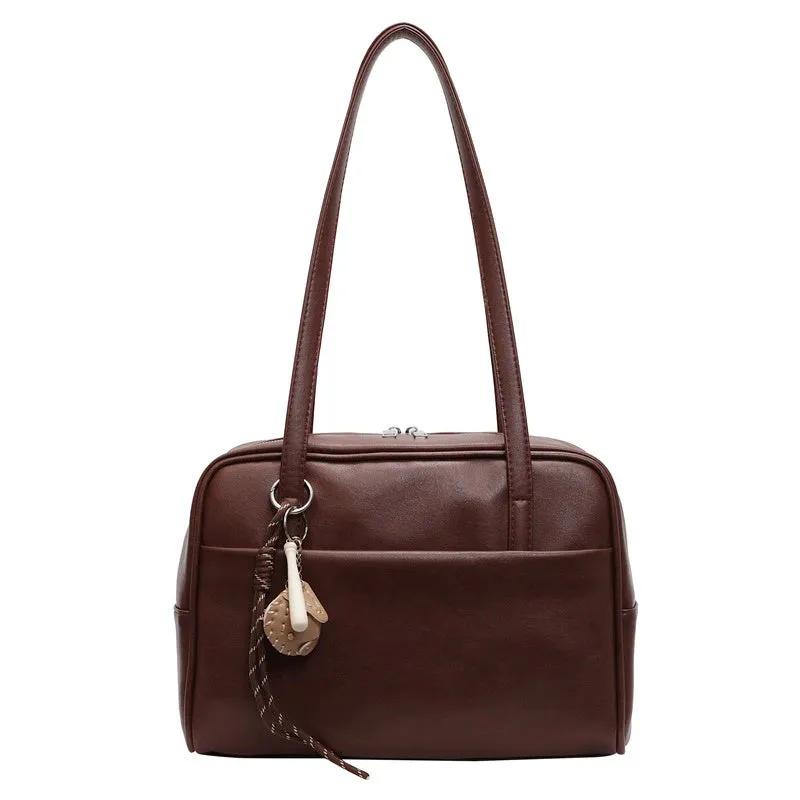 Women's urban simple PU bucket underarm bag with pendant detail in black, brown, coffee, and wine red colours.