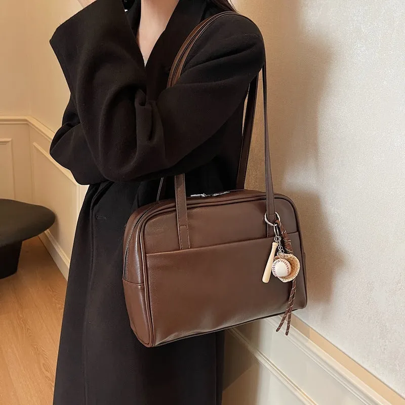 Women's urban simple PU bucket underarm bag with pendant detail in black, brown, coffee, and wine red colours.