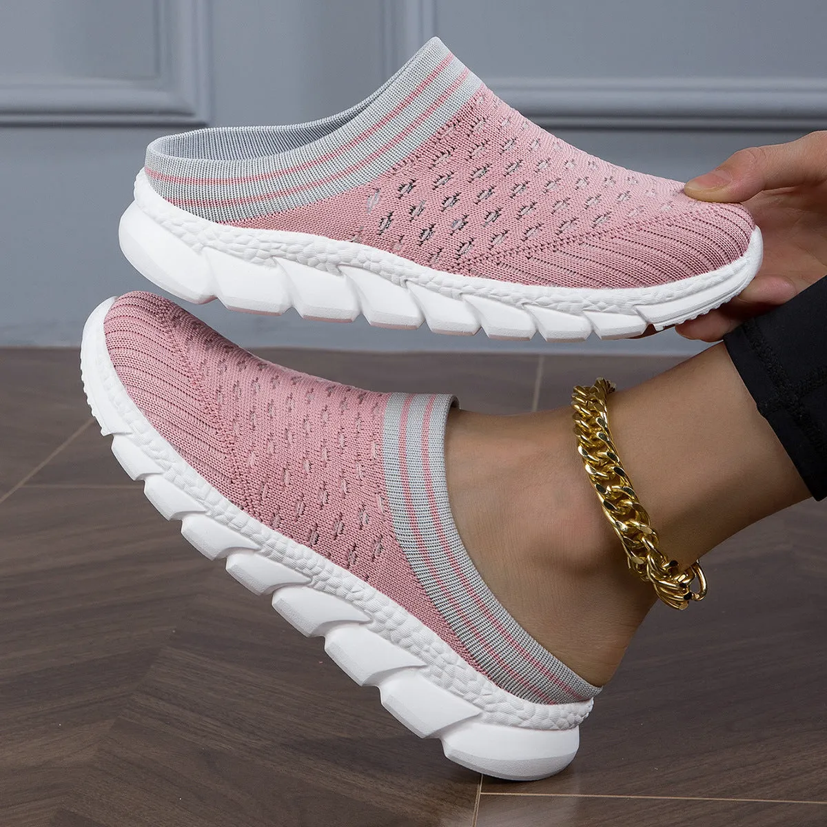 Women's black striped Flyknit slipper shoes with hollowed-out design on a viscose sole.