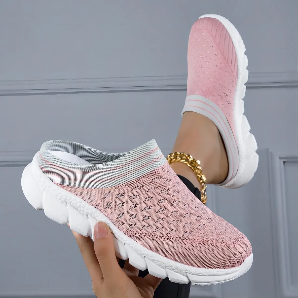 Women's black striped Flyknit slipper shoes with hollowed-out design on a viscose sole.