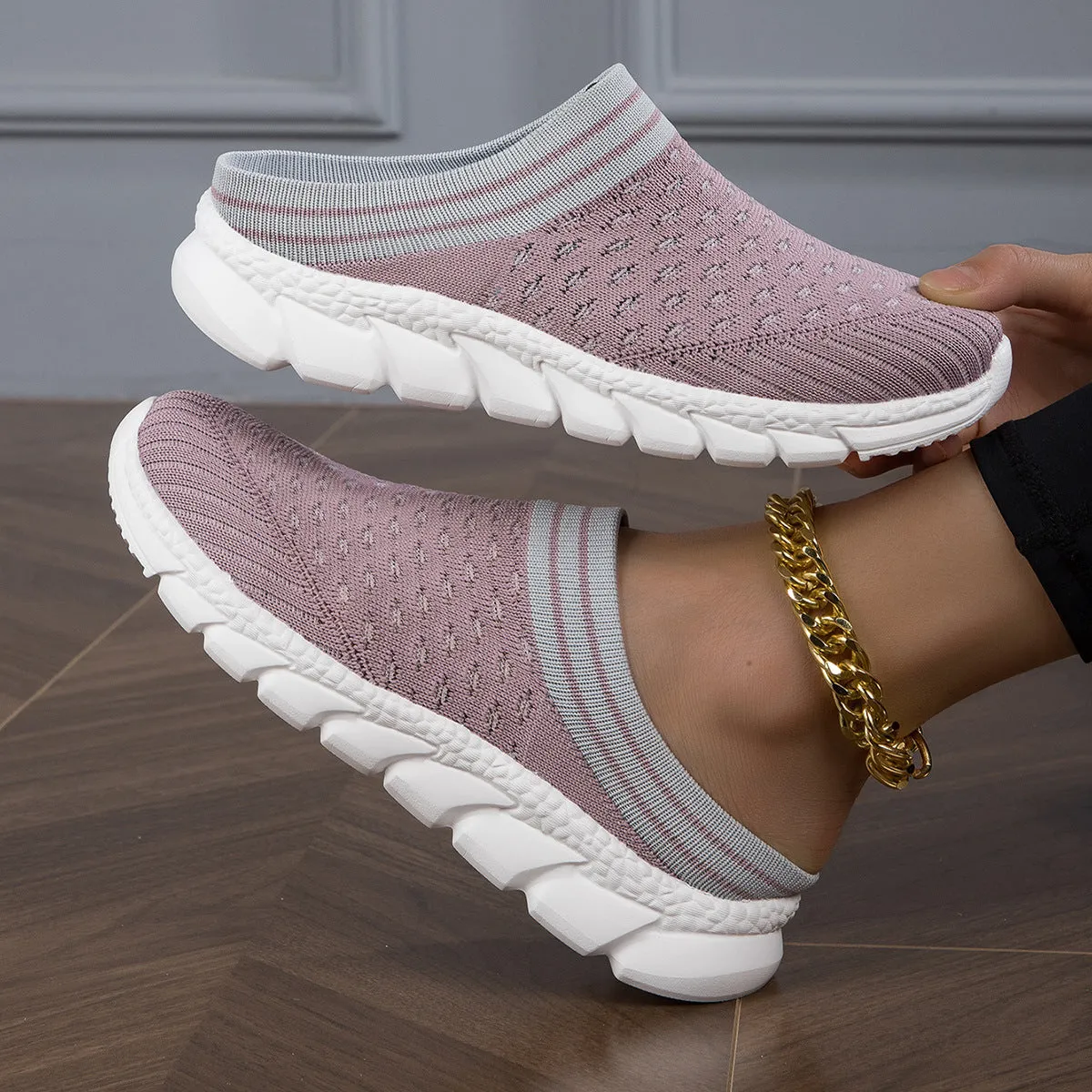 Women's black striped Flyknit slipper shoes with hollowed-out design on a viscose sole.