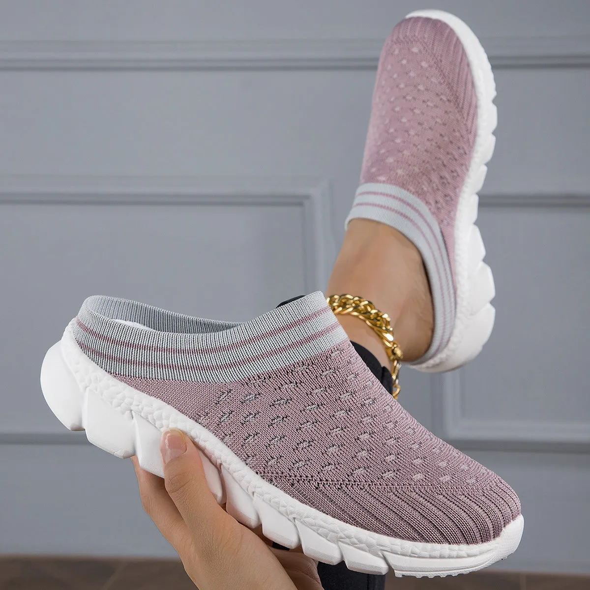 Women's black striped Flyknit slipper shoes with hollowed-out design on a viscose sole.