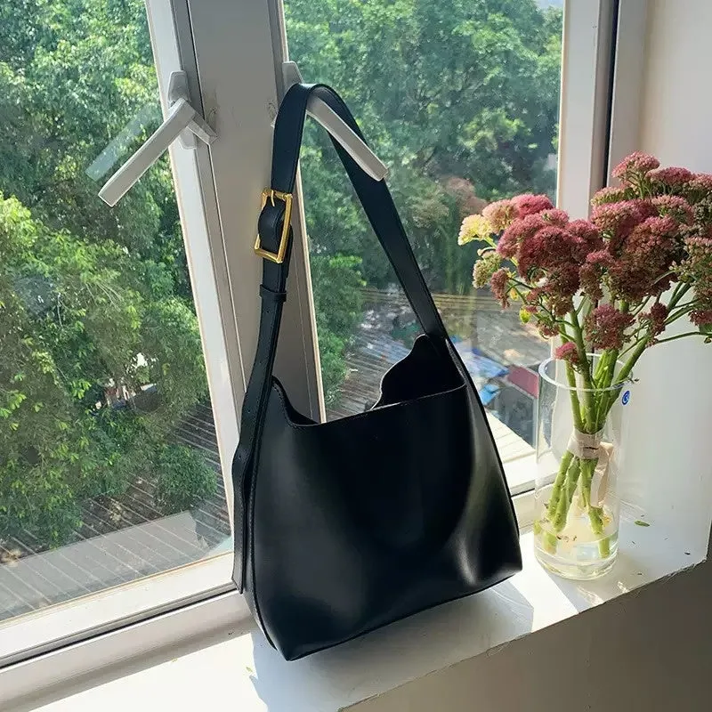 Women's soft PU shoulder bag with swing threads decoration showing black and brown colour options