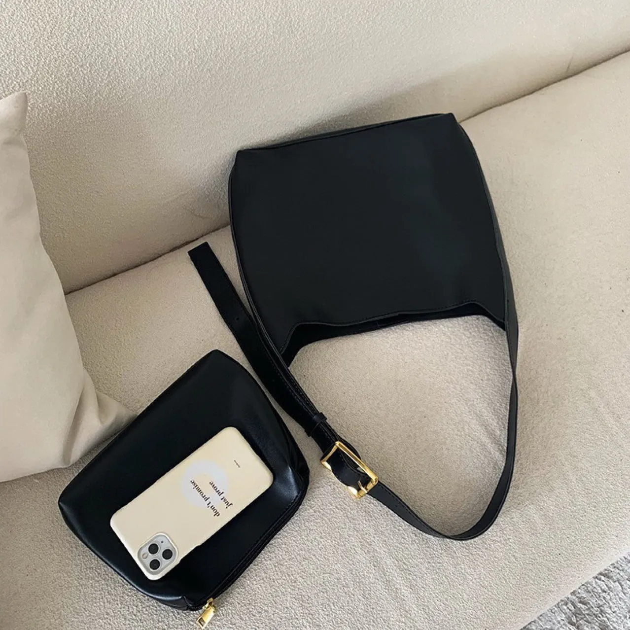 Women's soft PU shoulder bag with swing threads decoration showing black and brown colour options