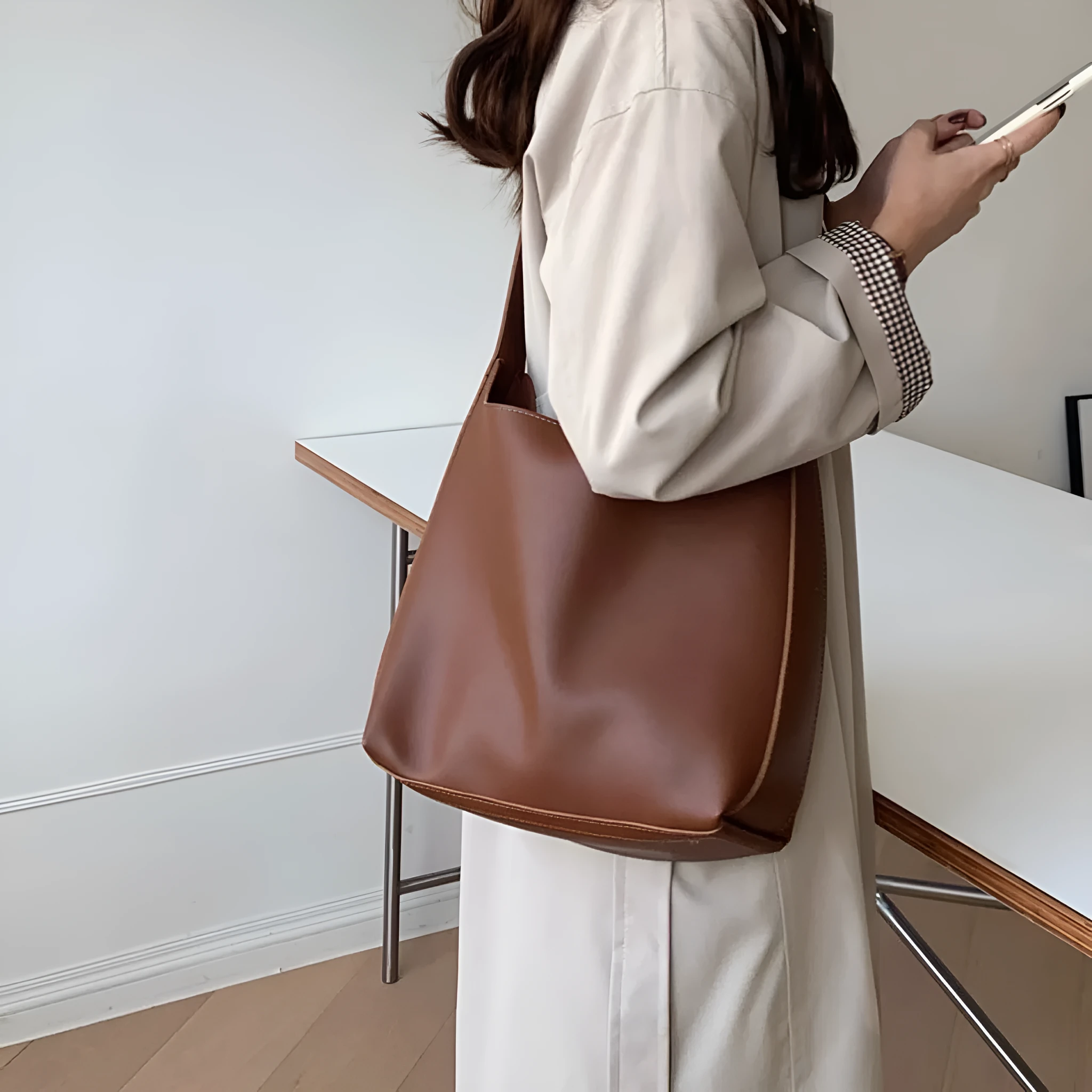 Women's soft PU shoulder bag with swing threads decoration showing black and brown colour options