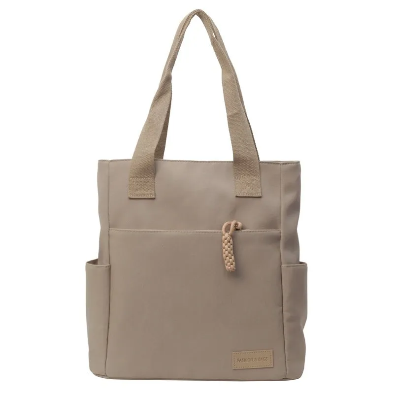 Women's large canvas satchel in beige with shoulder strap, horizontal square shape, and visible sewing thread details