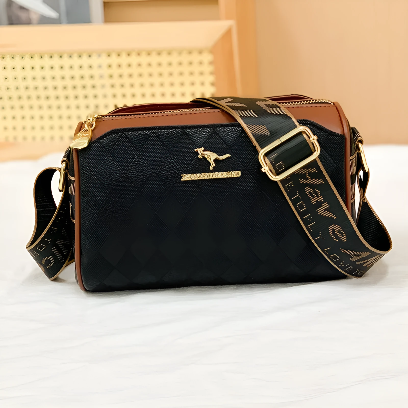 Soft PU leather crossbody messenger bag in black with visible sewing thread detail and single shoulder strap