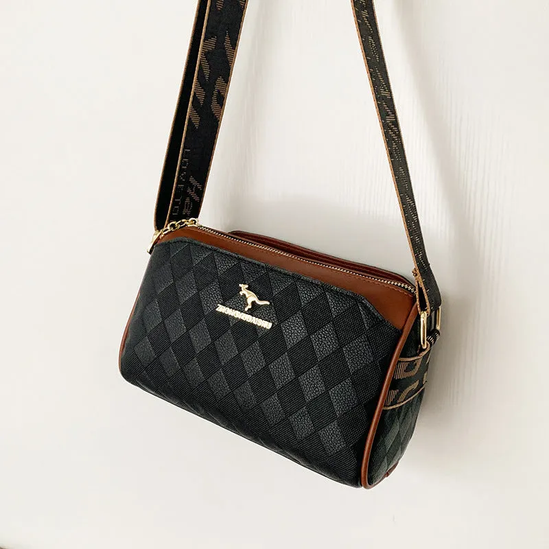 Soft PU leather crossbody messenger bag in black with visible sewing thread detail and single shoulder strap