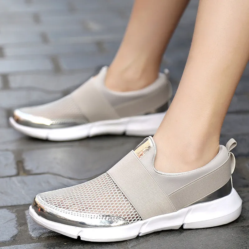 Blue, black, and grey women's low-cut mesh sneakers with a PU midsole on a hard floor.