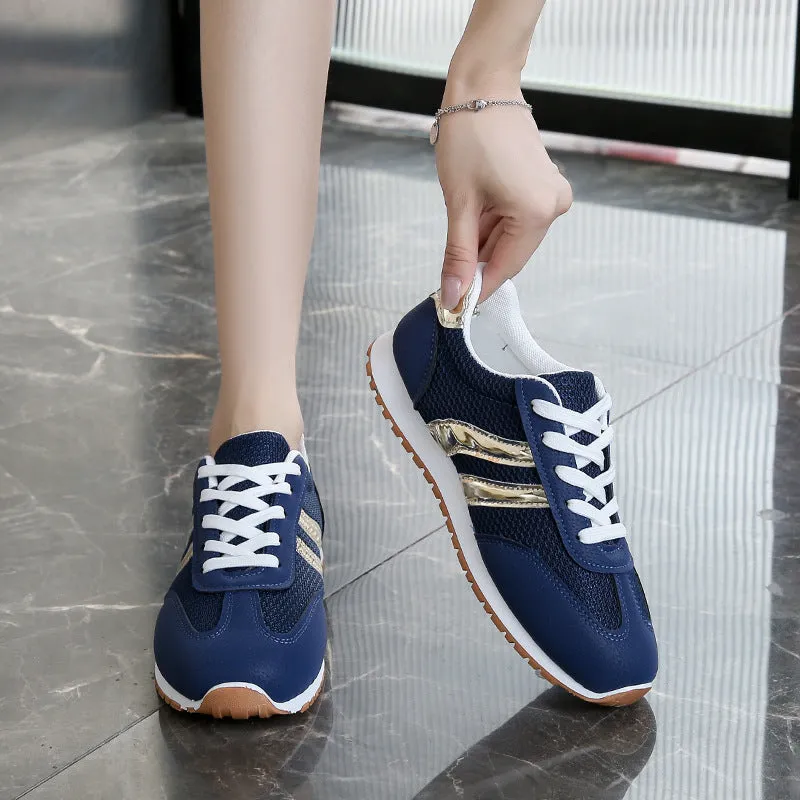 Blue women's lightweight sports shoes with cross straps and lace-up front on a flat rubber sole.