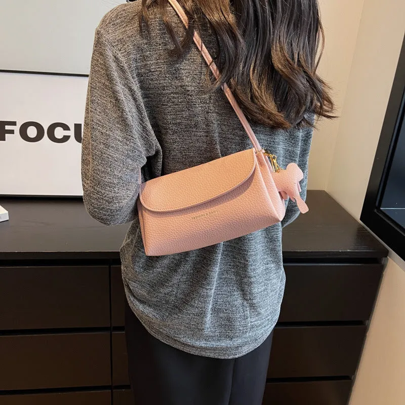 Soft PU small shoulder bag in khaki with pillow silhouette and sewing thread detail, 21cm wide.