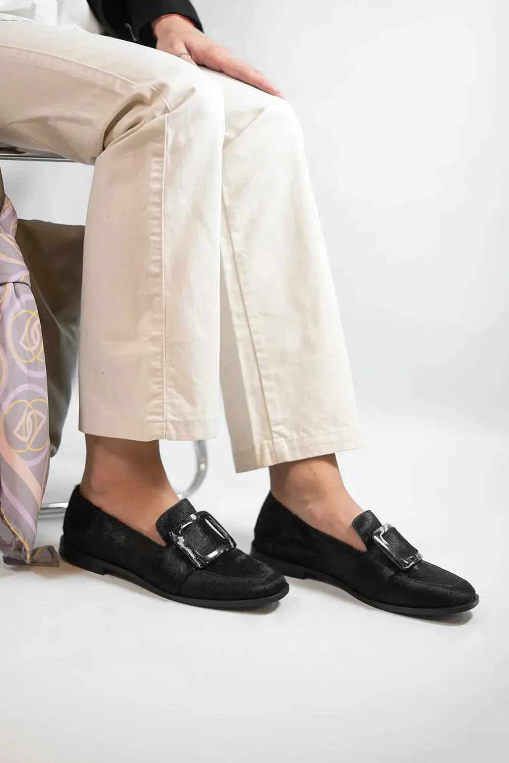 Low-cut black loafers for women with large square button and rhinestone details, round toe, low heel