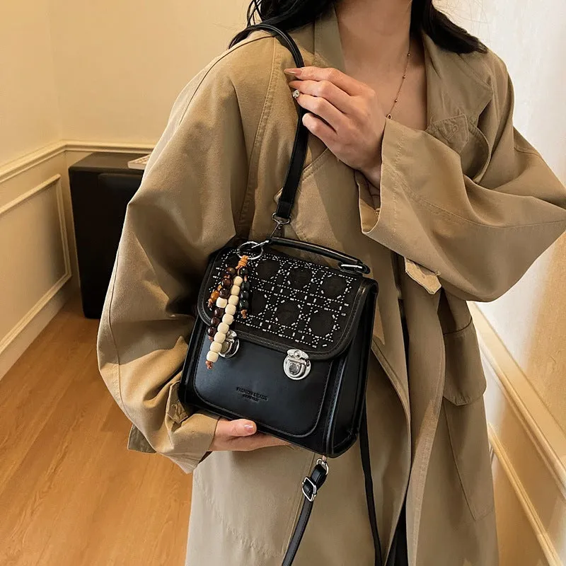 Small square PU leather messenger backpack for women with texture finish in black colour