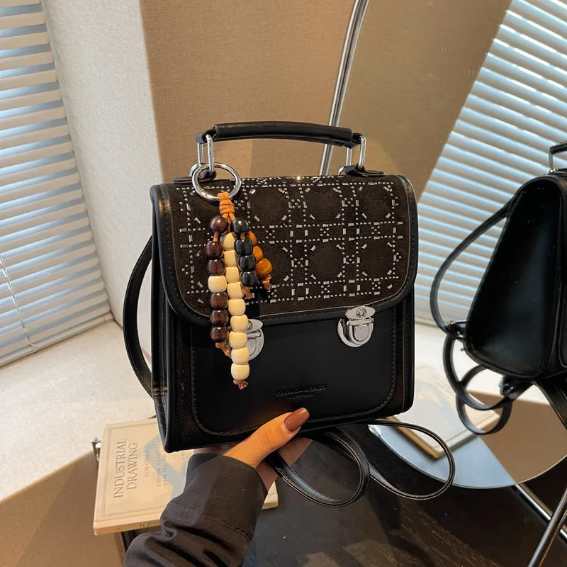 Small square PU leather messenger backpack for women with texture finish in black colour