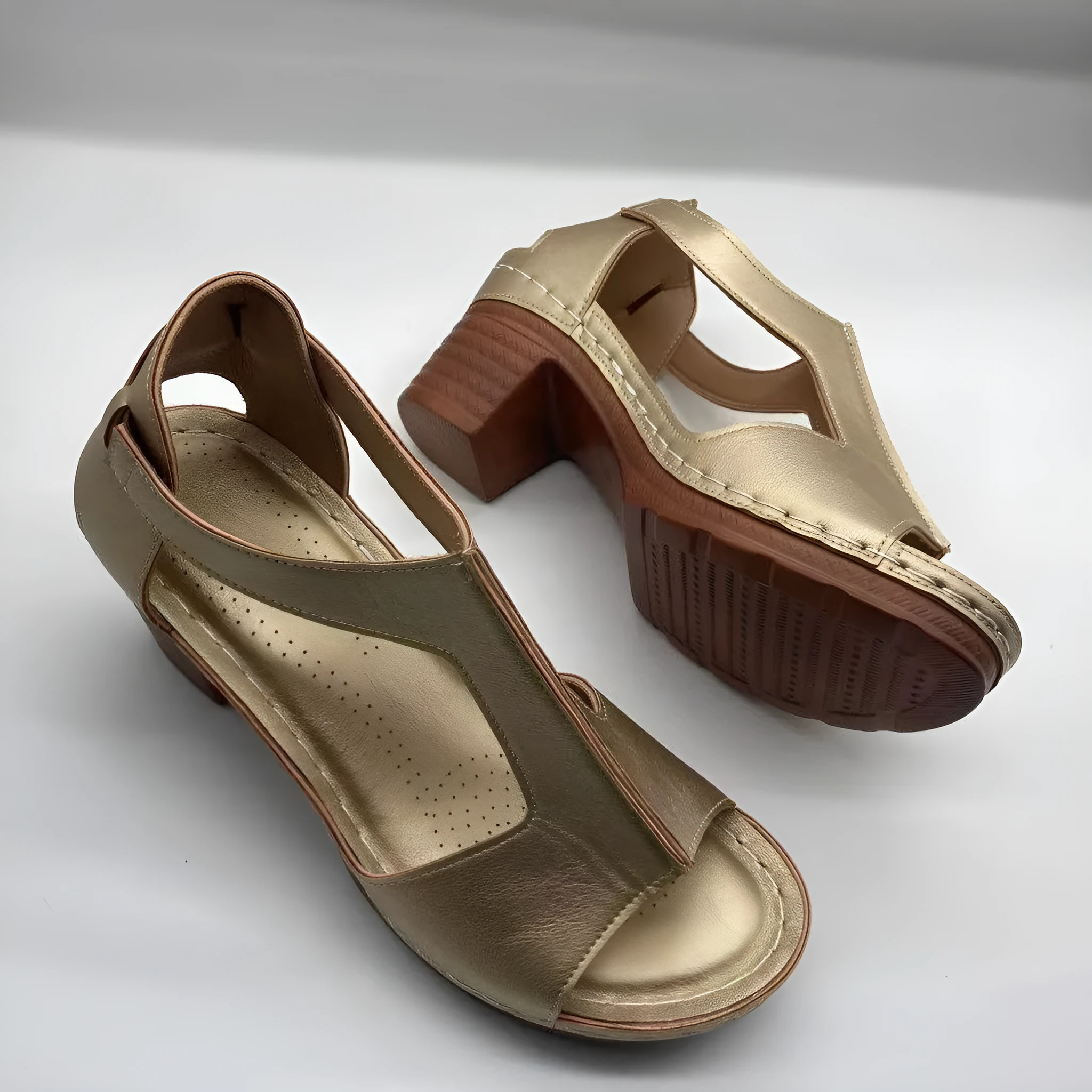 Womens beige Roman style wedge sandals with open peep toe and silver buckle strap on a low heel.