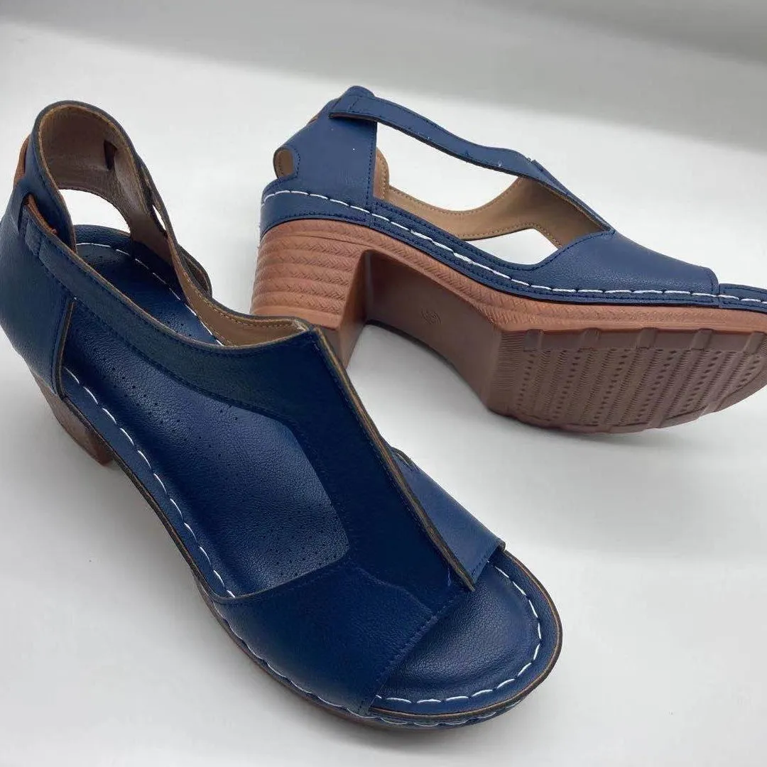 Womens beige Roman style wedge sandals with open peep toe and silver buckle strap on a low heel.