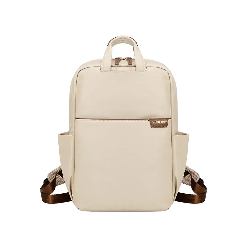 Large canvas travel backpack for women showing multiple internal compartments and zippered pockets
