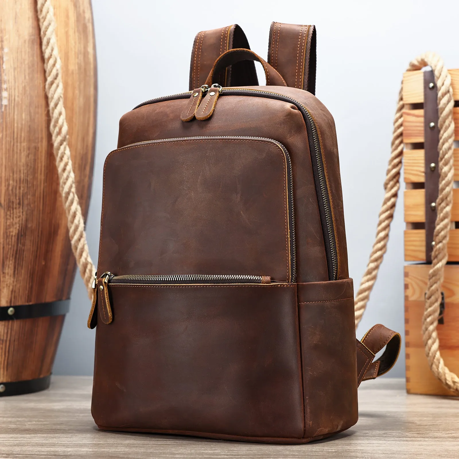 Men's genuine leather backpack in black, first layer cowhide, with a top handle and zipped main compartment