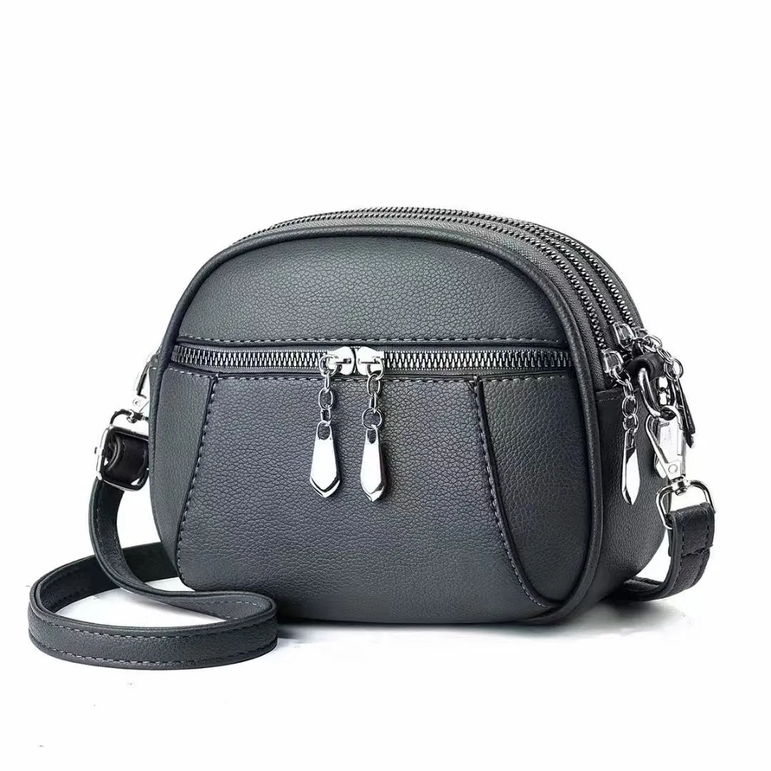 Solid colour small round bag with stitch detailing and zip closure, in multiple colours