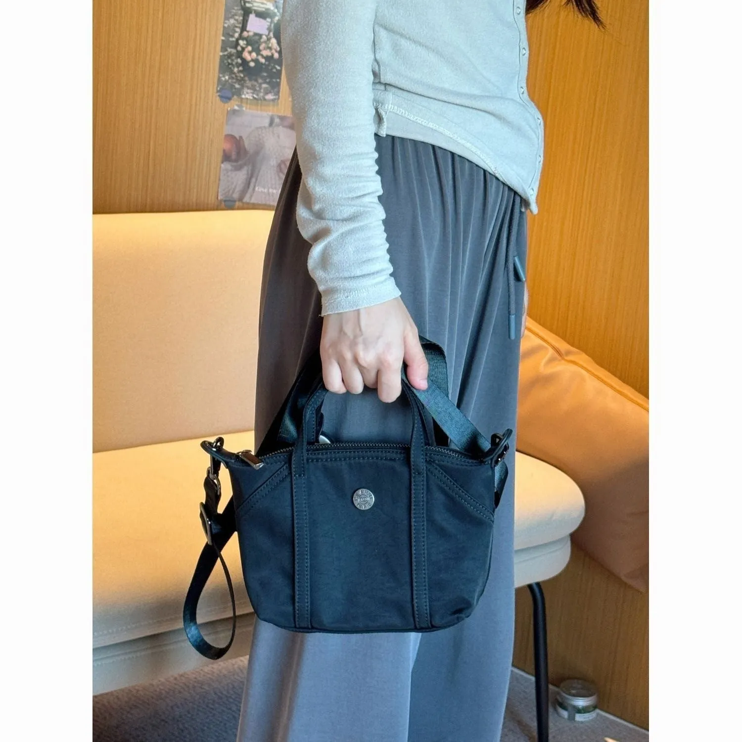 Casual lightweight nylon crossbody bag in dumpling shape, available colours black brown orange pink yellow, with pendant